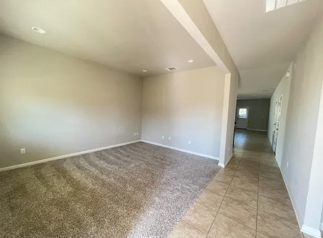 en empty room with an entrance to other room