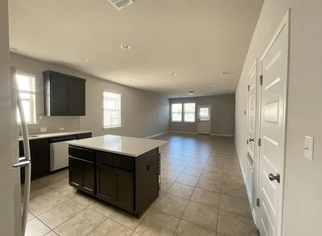 a kitchen with a stove a sink and a refrigerator