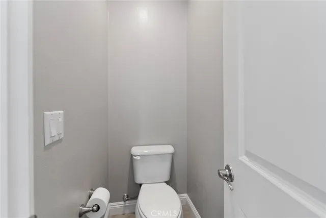 a white toilet sitting next to a white sink