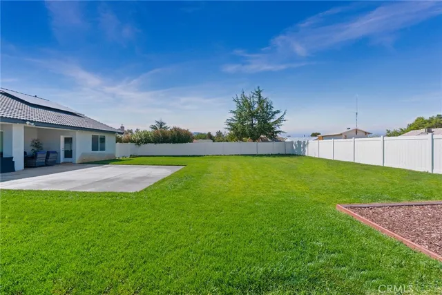 a view of a house with a backyard
