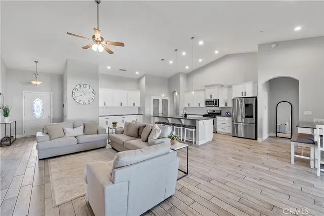 a living room with furniture and kitchen view