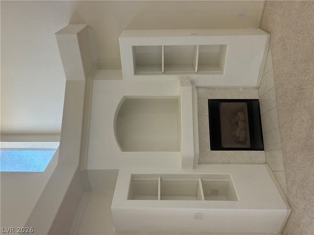 5272 Island Chain Road Las Vegas, NV 89118 - Photo 19 of 39 A refined fireplace with built-in shelving adds architectural interest to this inviting room.