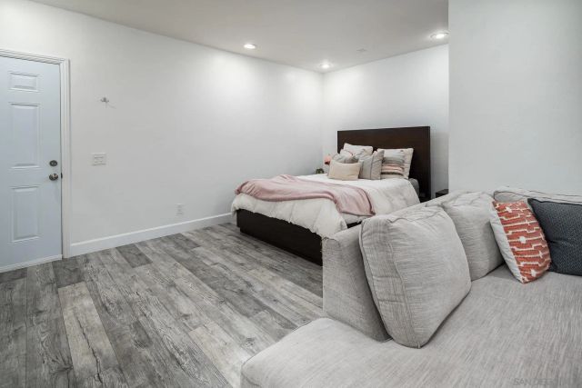 a bedroom with bed and a night stand