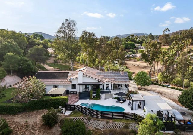 a view of a house with garden and sitting area