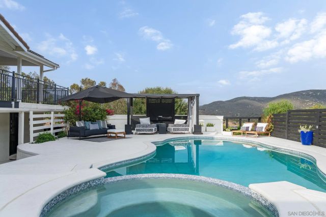 a view of a house with backyard porch and sitting area