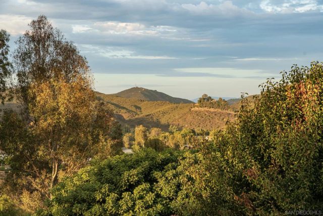 a view of a large building with mountains in the background