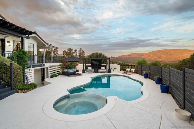 a roof deck with table and chairs a barbeque