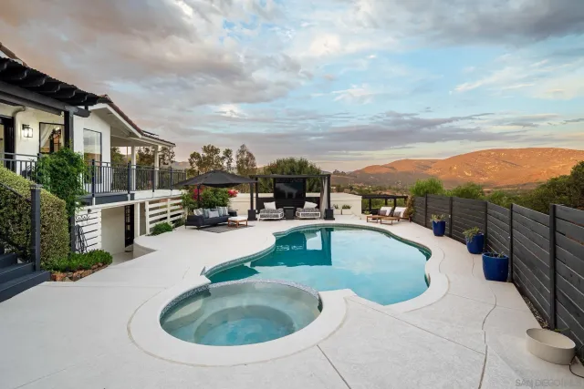 a roof deck with table and chairs a barbeque