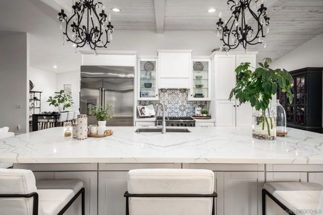 a kitchen with a sink and a table with chairs
