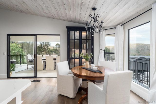 a view of a dining room with furniture large windows and wooden floor