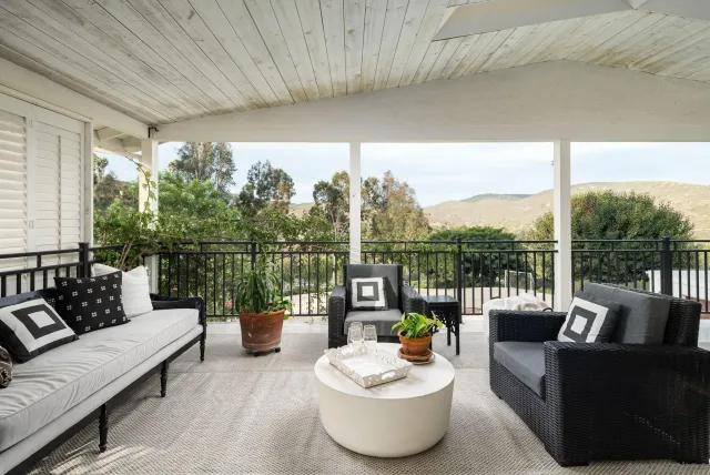 a view of a patio with a table and chairs
