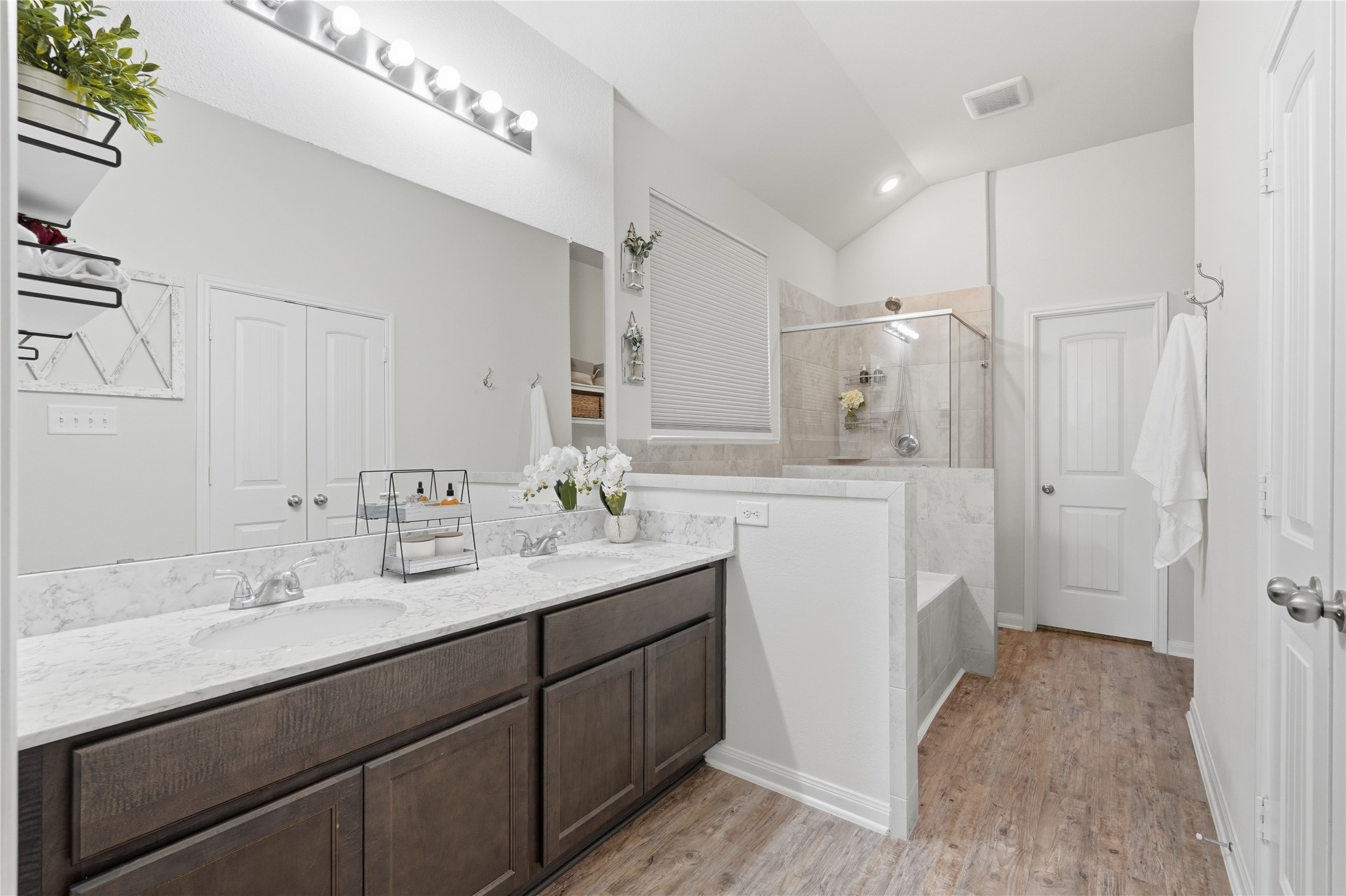 3579 Korina Way Conroe, TX 77306 - Photo 13 of 20 a bathroom with a sink a mirror a vanity and shower