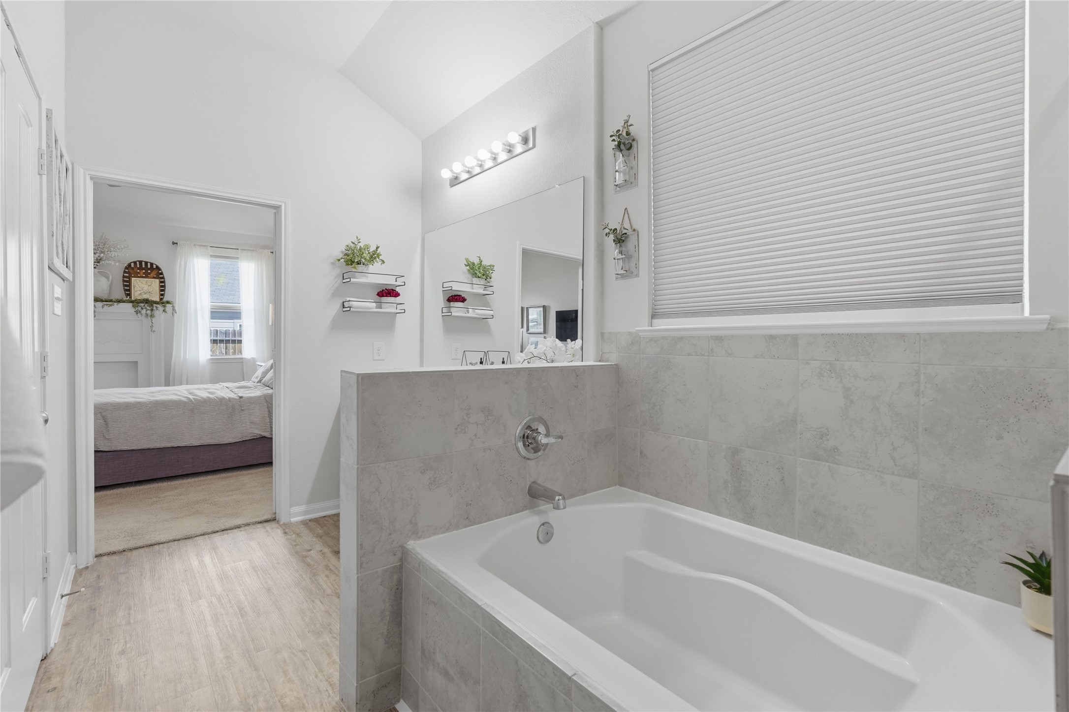 3579 Korina Way Conroe, TX 77306 - Photo 14 of 20 a bathroom with a tub a sink and a large mirror