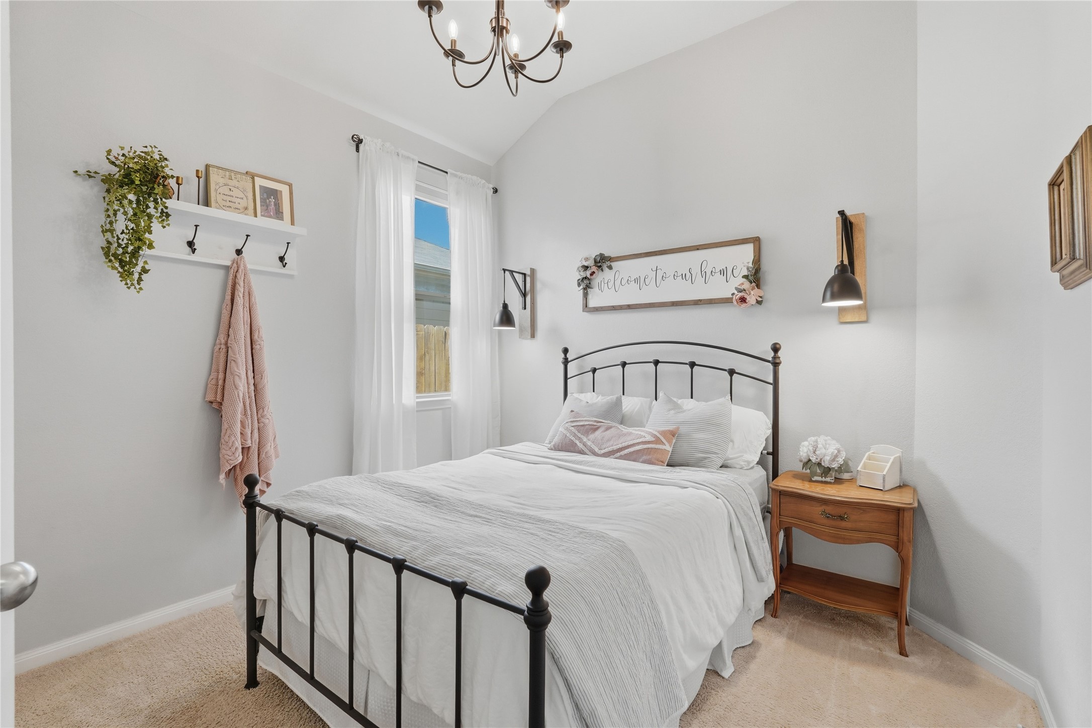 3579 Korina Way Conroe, TX 77306 - Photo 15 of 20 a bedroom with a bed and a chandelier