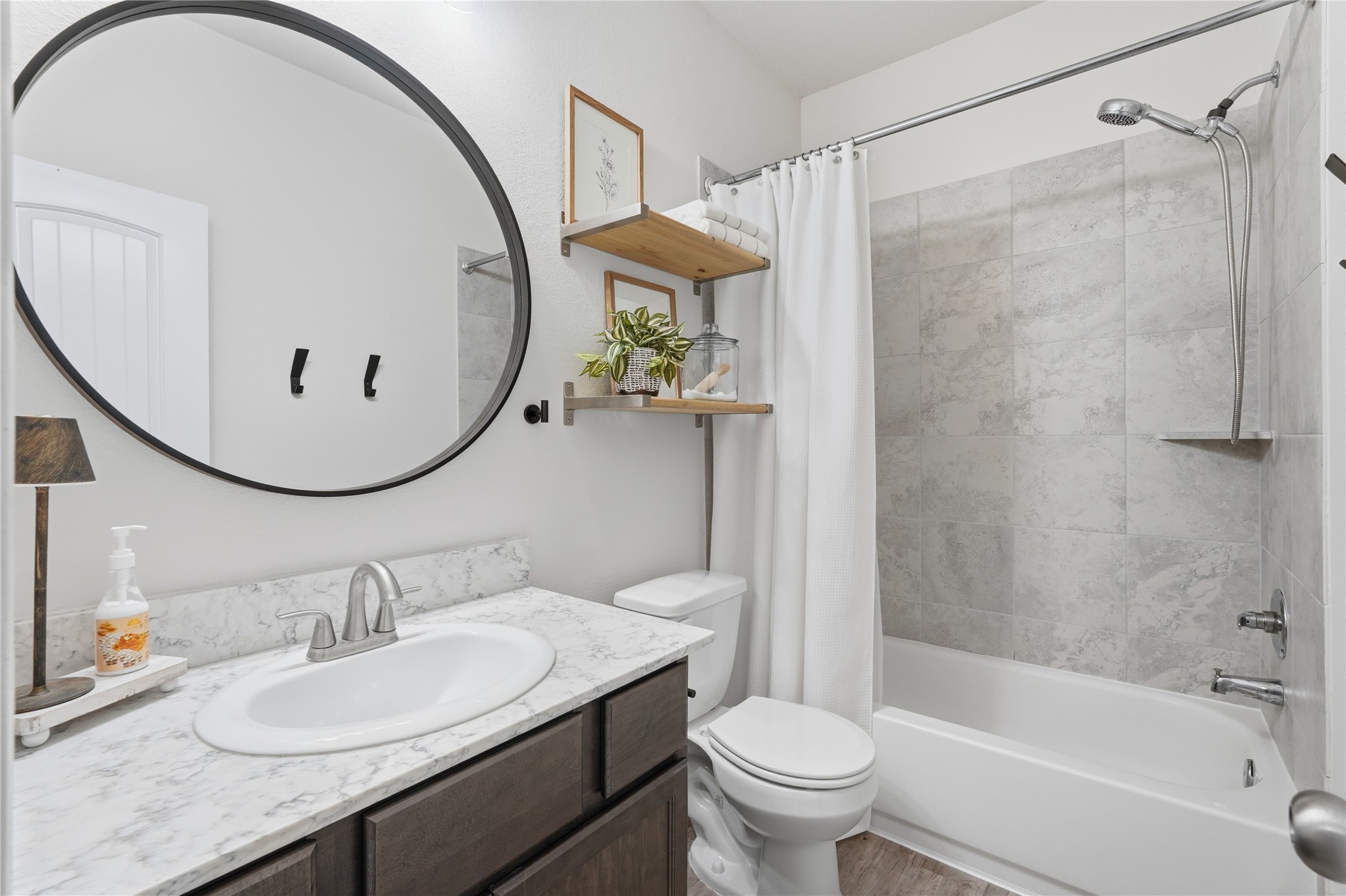 3579 Korina Way Conroe, TX 77306 - Photo 16 of 20 a bathroom with a sink a toilet and a mirror