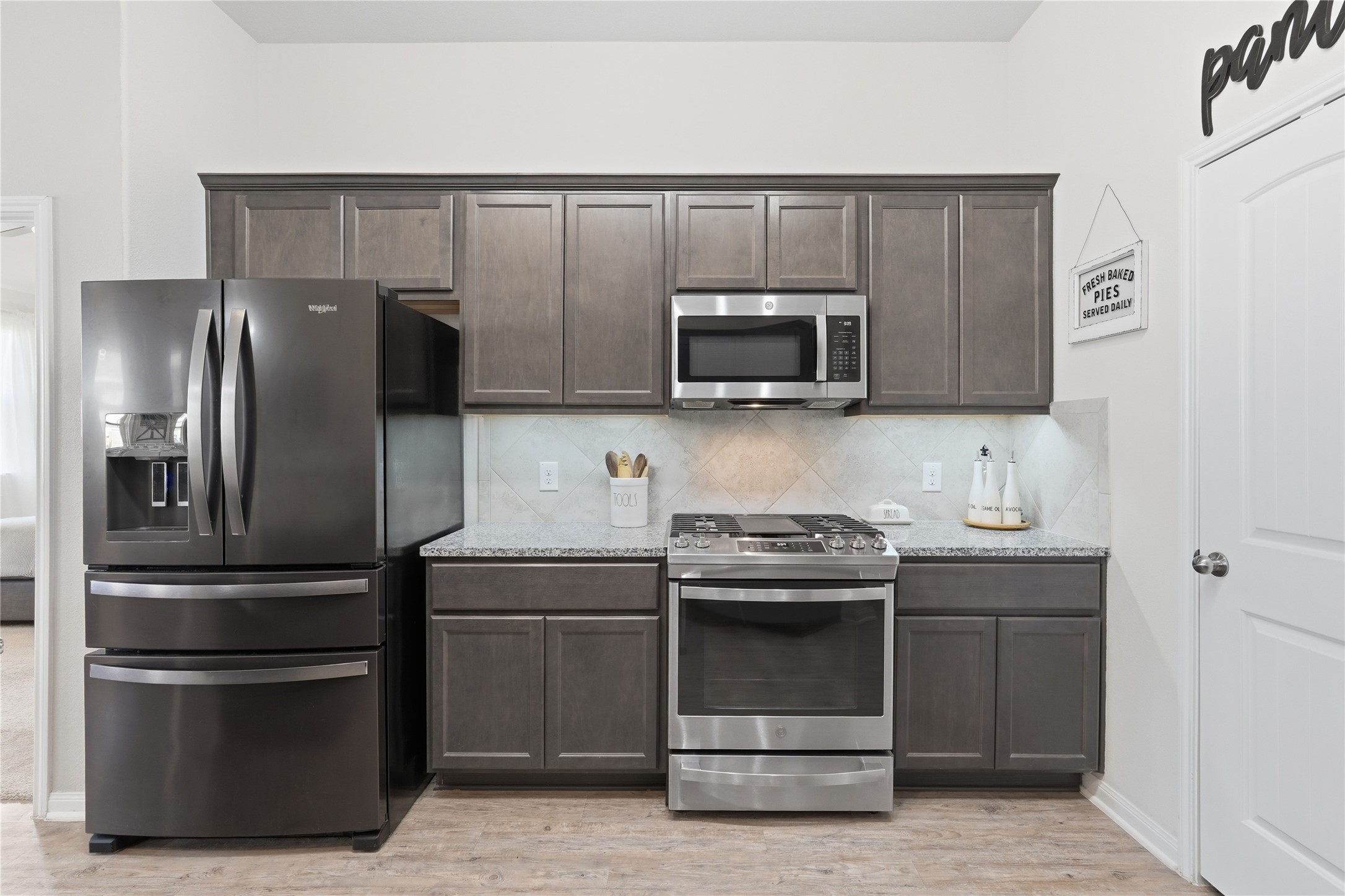 3579 Korina Way Conroe, TX 77306 - Photo 9 of 20 a kitchen with a refrigerator stove and microwave