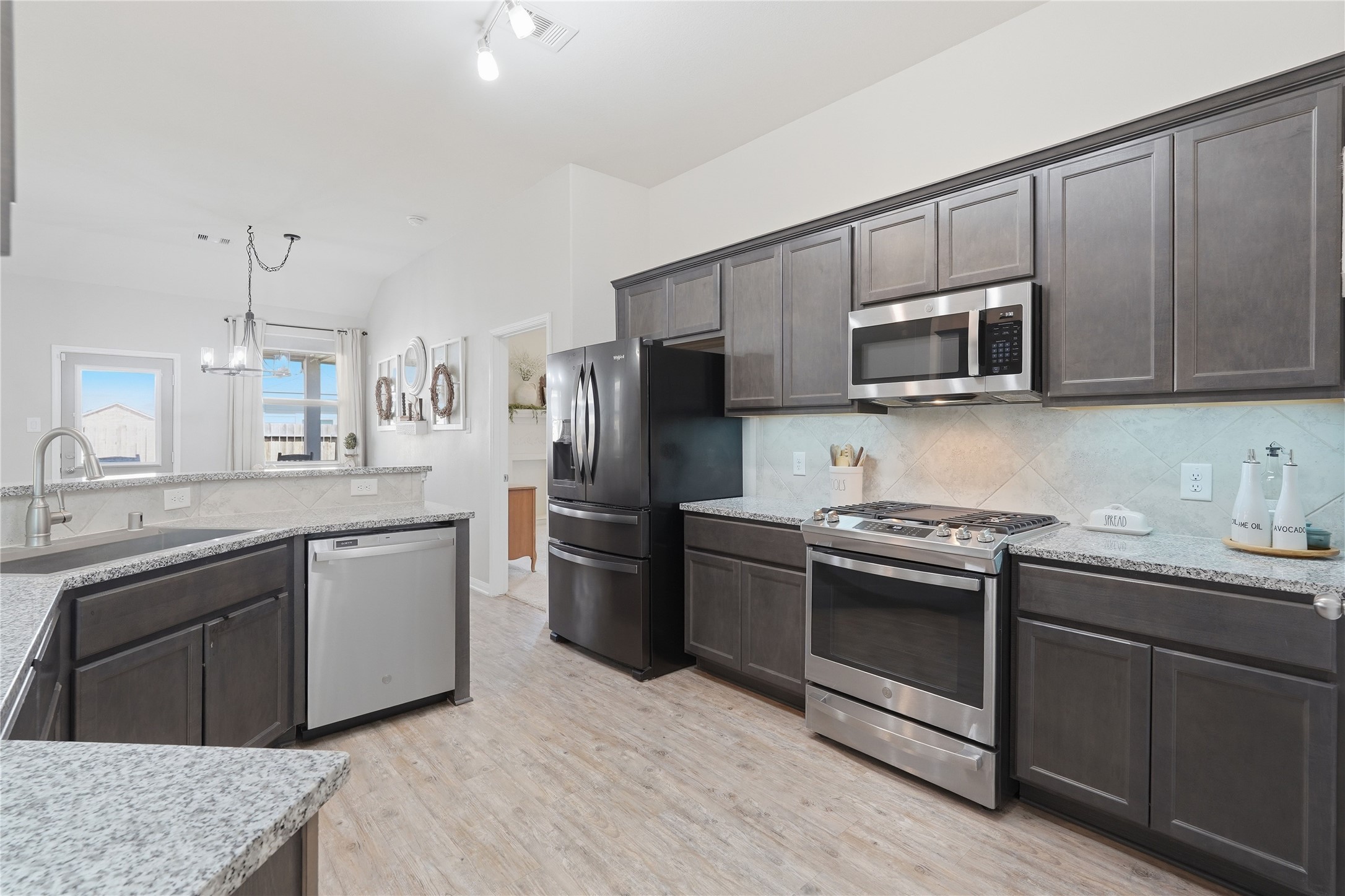 3579 Korina Way Conroe, TX 77306 - Photo 10 of 20 a kitchen with stainless steel appliances granite countertop a stove a sink dishwasher a refrigerator and a microwave oven