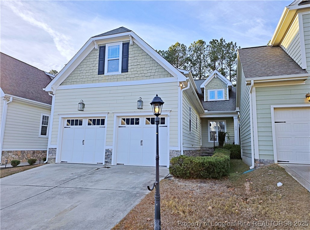 a view of a house with a yard and garage