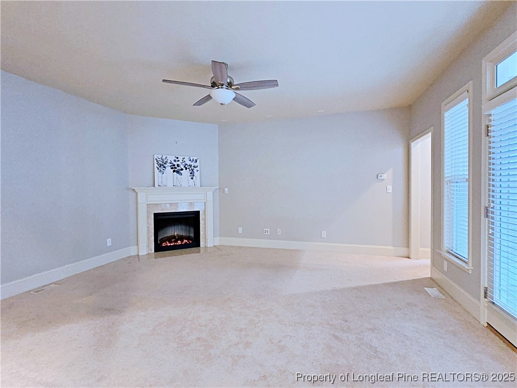 175 Pine Hawk Drive Spring Lake, NC 28390 - Photo 14 of 41 a view of an empty room with a fireplace and a window