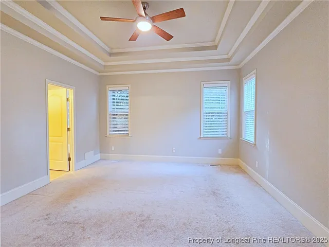 an empty room with a window and a ceiling fan