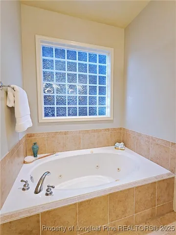 a bathroom with a bathtub and a window