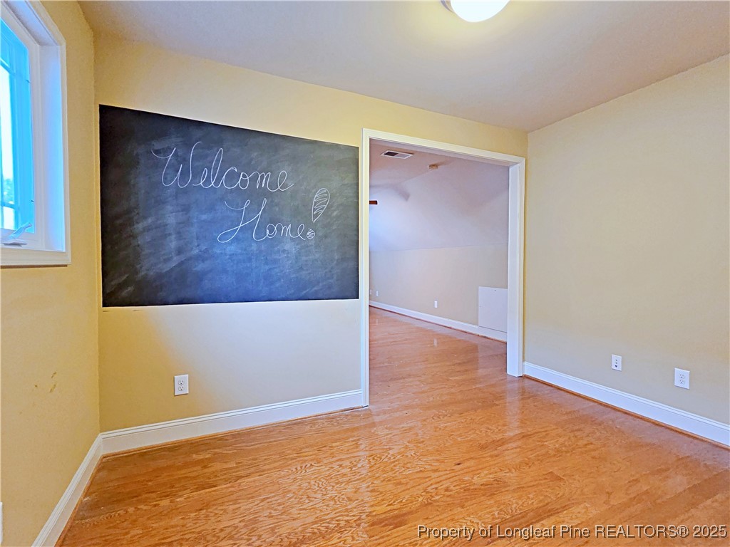 175 Pine Hawk Drive Spring Lake, NC 28390 - Photo 27 of 41 an empty room with wooden floor and windows