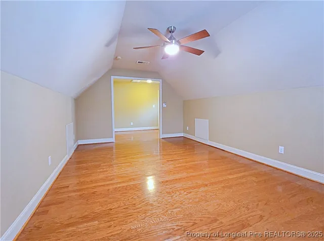 a view of empty room with wooden floor