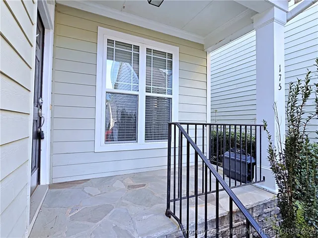 a view of a balcony with a couple of flower plants