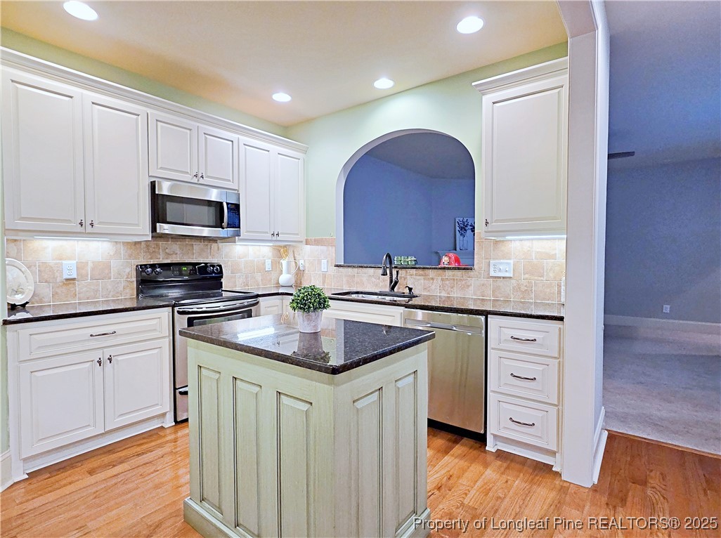 175 Pine Hawk Drive Spring Lake, NC 28390 - Photo 9 of 41 a kitchen with stainless steel appliances granite countertop a sink stove and cabinets