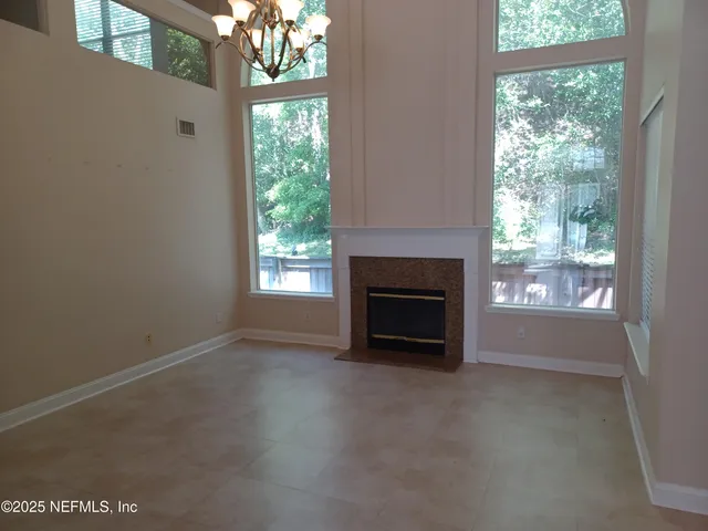a view of empty room with a fireplace