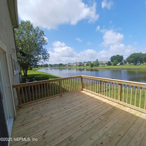a view of balcony with wooden floor