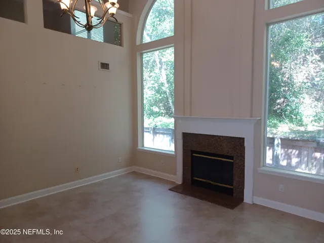a view of empty room with a fireplace