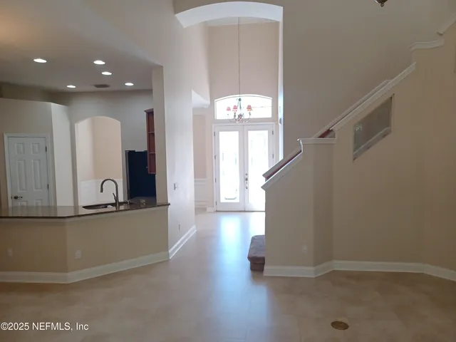 a view of a living room and entryway with wooden floor
