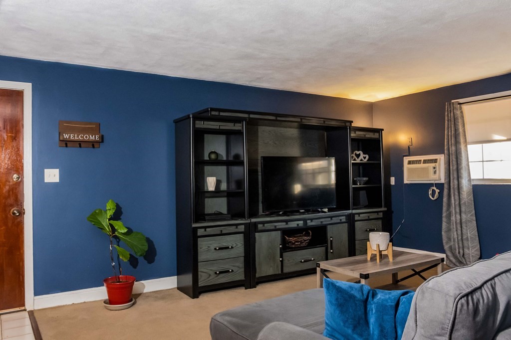 1 Walker Road, Unit 1 North Andover, MA 01845 - Photo 3 of 17 a living room with furniture and a flat screen tv