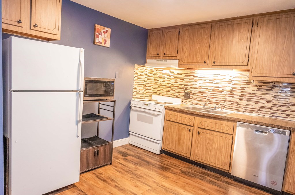 1 Walker Road, Unit 1 North Andover, MA 01845 - Photo 6 of 17 a kitchen with granite countertop cabinets appliances and wooden floor