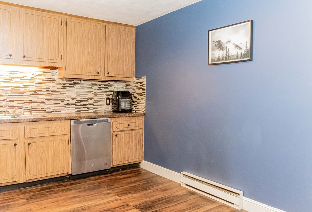 1 Walker Road, Unit 1 North Andover, MA 01845 - Photo 7 of 17 a view of a kitchen with marble countertop and wooden floor