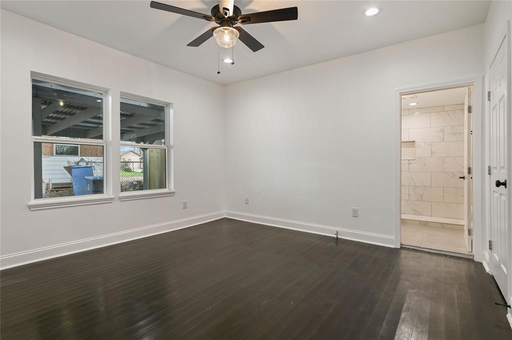 1106 West Chestnut Street Denison, TX 75020 - Photo 9 of 38 Empty room with dark hardwood / wood-style floors and ceiling fan