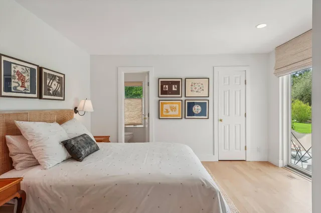 a bedroom with a large bed and a window