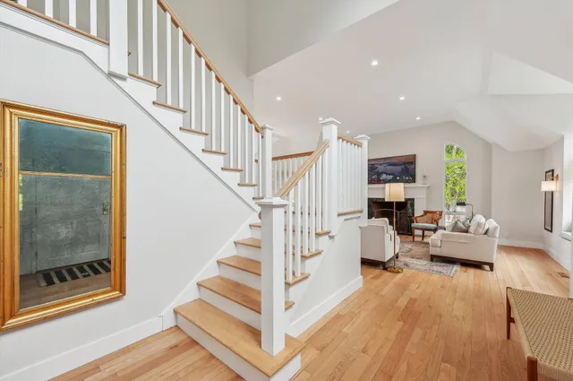 a view of entryway livingroom and hall with wooden floor