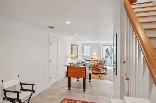a dining room with furniture and wooden floor