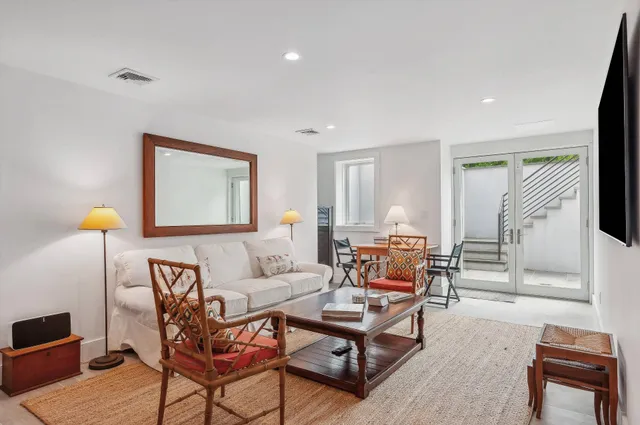 a living room with furniture and a lamp