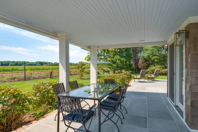 a view of a porch with chairs and backyard