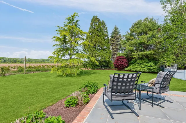 a view of a chair and table in the garden