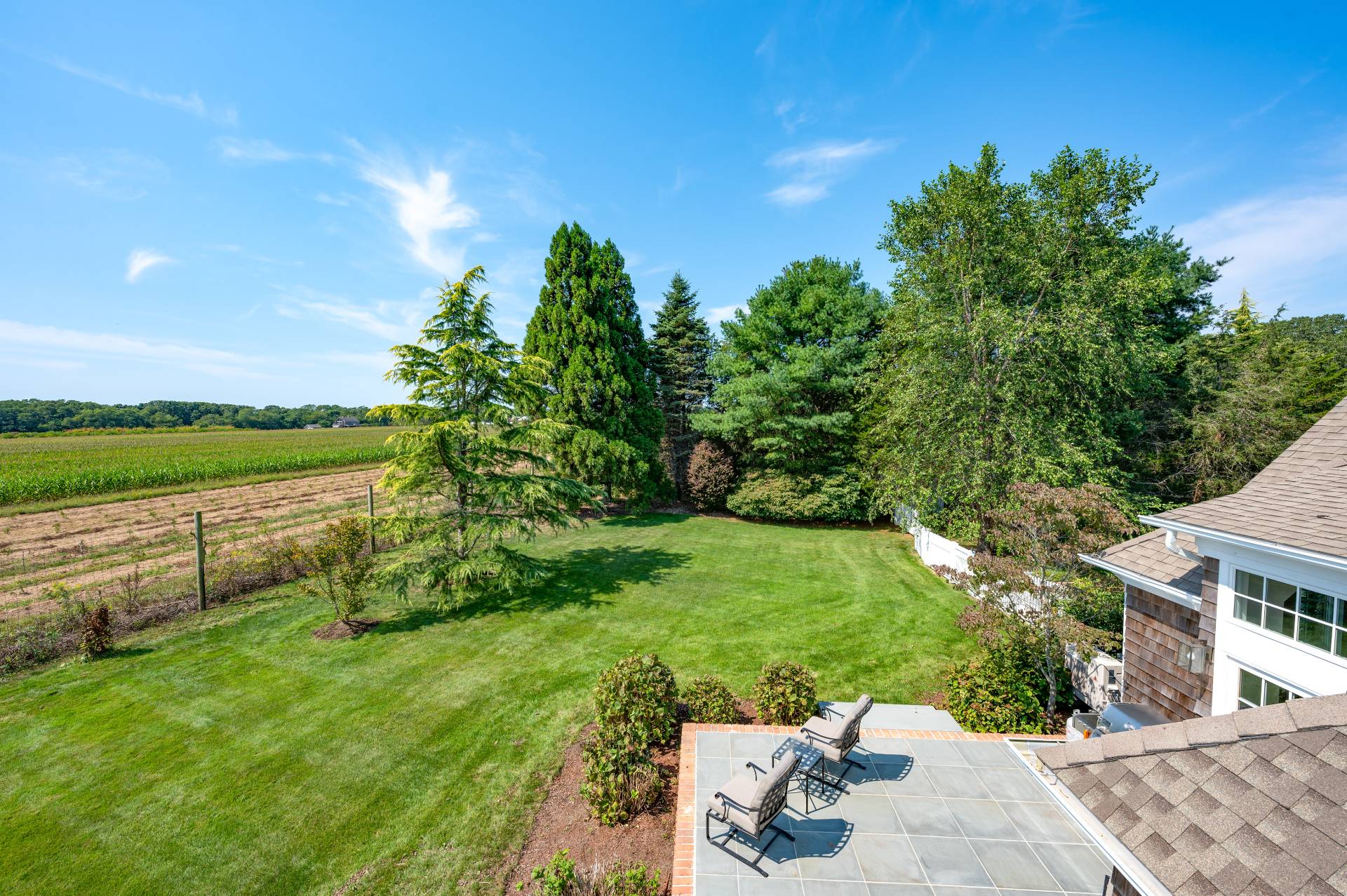 127 Narrow Lane South Water Mill, NY 11976 - Photo 32 of 37 a view of a garden with a building in the background