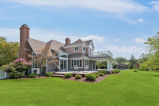 a front view of a house with a garden and plants