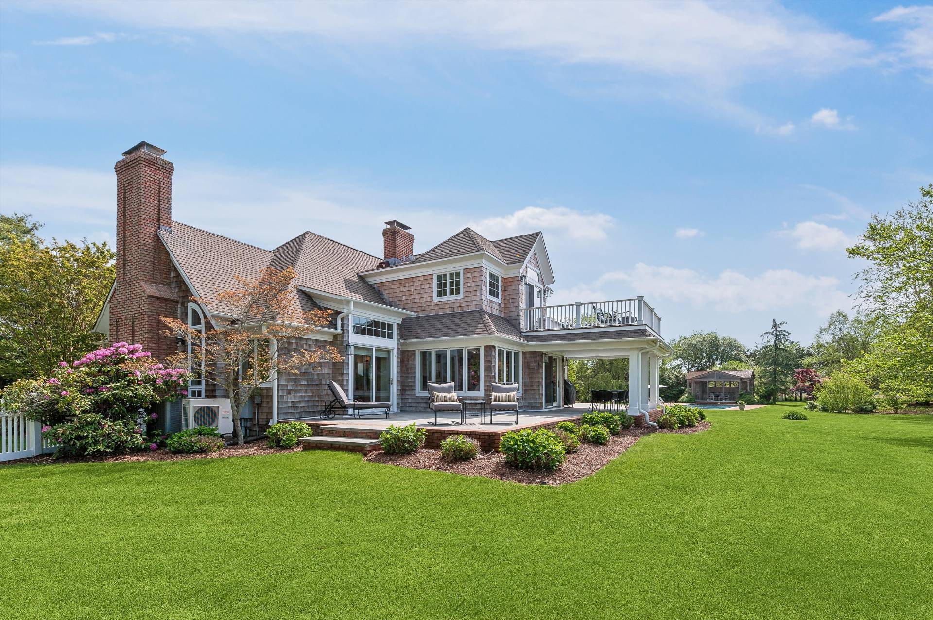127 Narrow Lane South Water Mill, NY 11976 - Photo 36 of 37 a front view of a house with a garden and plants