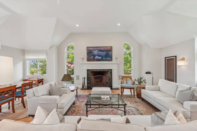 a living room with furniture a rug and a fireplace