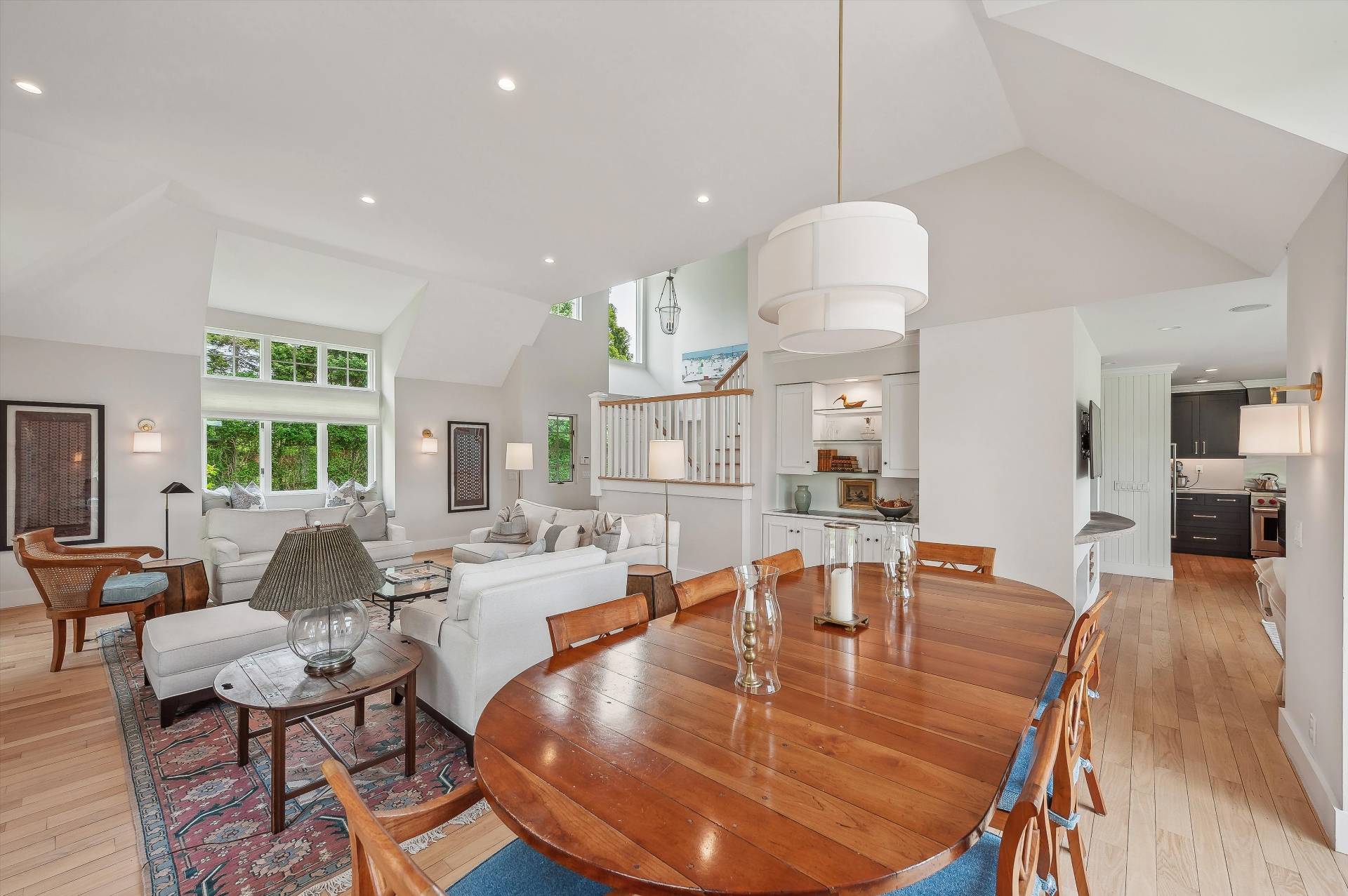 127 Narrow Lane South Water Mill, NY 11976 - Photo 8 of 37 a dining room with wooden floor a chandelier a glass table and chairs