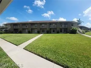 a view of a house with a yard and garage