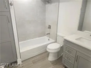 a bathroom with a sink a toilet and a bathtub